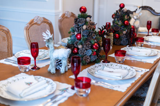 General view of empty Christmas dinner table, slow motion video of empty Christmas table during Pandemic, Christmas themed dining table, decorated Christmas tree and wooden deer and christmas decorations on dining table