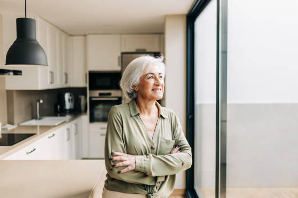 istock Cheerful senior woman looking away thoughtfully 1419246752