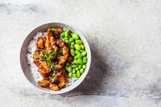 Teriyaki chicken with rice and edamame beans in gray bowl. Japanese cuisine. stock photo