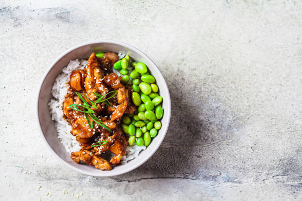 teriyaki chicken with rice and edamame beans in gray bowl. japanese cuisine. - edamame imagens e fotografias de stock