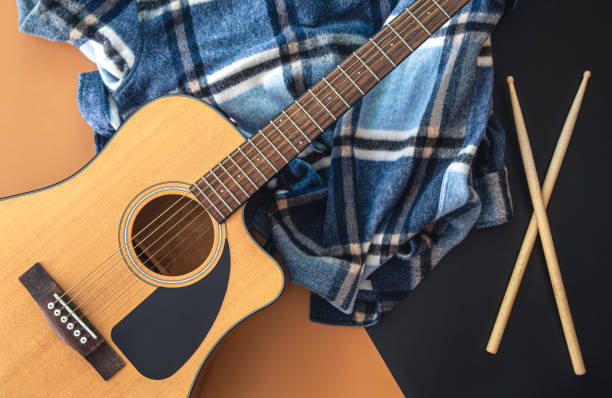 istock Music background with guitar and drumsticks, top view. 1419248600