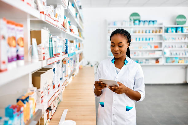 istock Black female pharmacist working on digital tablet in drugstore. 1419248699