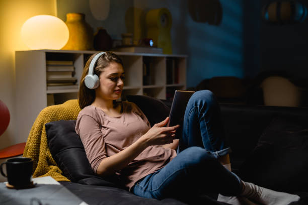 istock young woman relaxing at home using digital tablet 1419250065