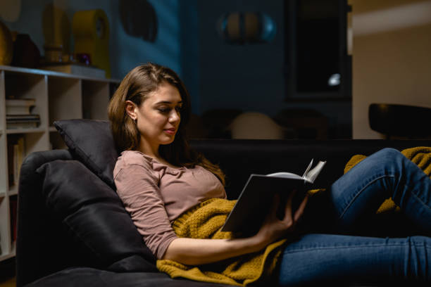 istock young woman relaxing at home reading book 1419250076