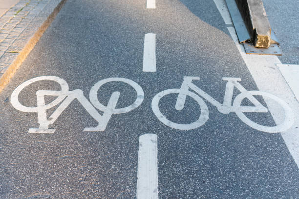 istock White bicycle symbols on the asphalt marking the bicycle lanes 1419251933