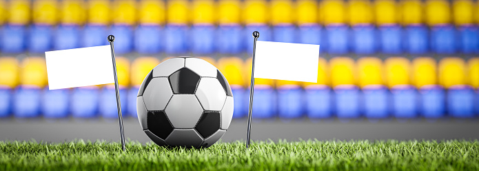 Soccer ball on the grass - blank flags mockup - template of the flags of the teams playing the match