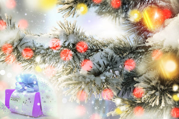 istock Present or gift box and Christmas tree branches with golden bokeh lights with snowflakes pattern. Holiday greeting card. New Year and Christmas atmospheric mood 1419254283