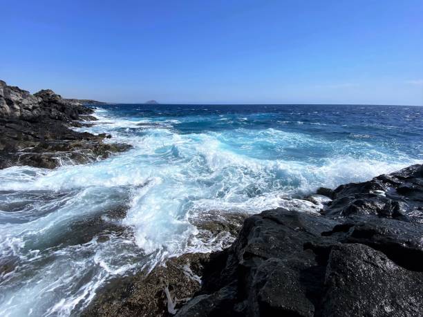 istock The wild ocean and waves hit the rocky volcanic coastline 1419254607