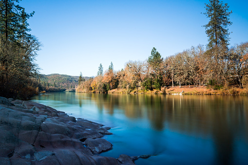 Beautiful view at the Rogue River calm water in golden season. Oregon, USA
