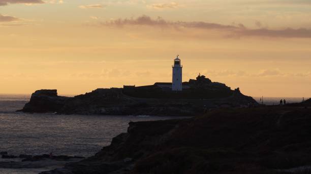 istock Scenic view of a lighthouse on a rocky coast at sunset 1419256032