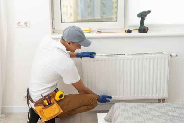 istock The process of installing a battery to water pipes. Heating system. Nearby standing master 1419261800