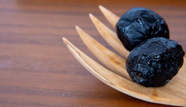 istock olives on wooden spoon 1419268011