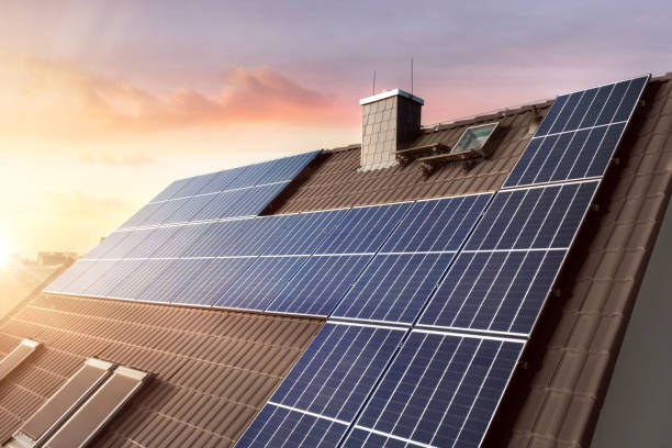 Roof of a family home with photovoltaic system Rooftop of a sustainable German family home with solar panels at sunset. industrial equipment stock pictures, royalty-free photos & images