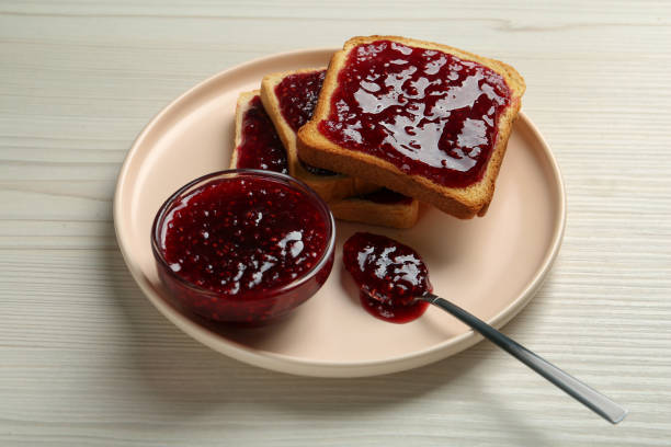 istock Delicious toasts with jam served on white wooden table 1419268173