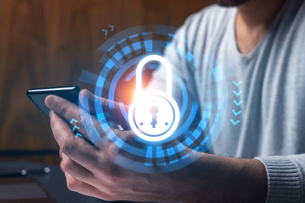 istock Man using phone. Hands typing smartphone. Double exposure with lock icon hologram. Close up. Datum cyber safety concept. Protection from hacker attack. 1419268893