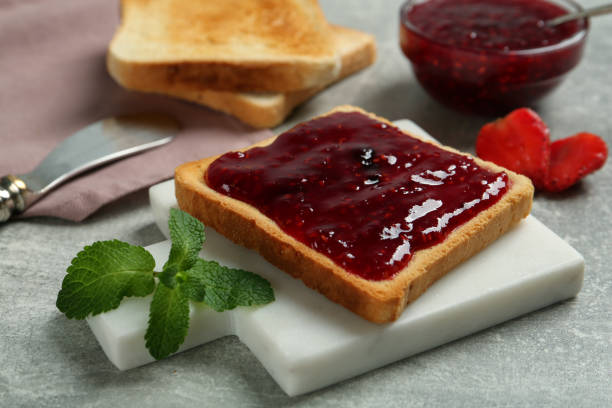 istock Delicious toast with jam and mint on light grey table, closeup 1419269164