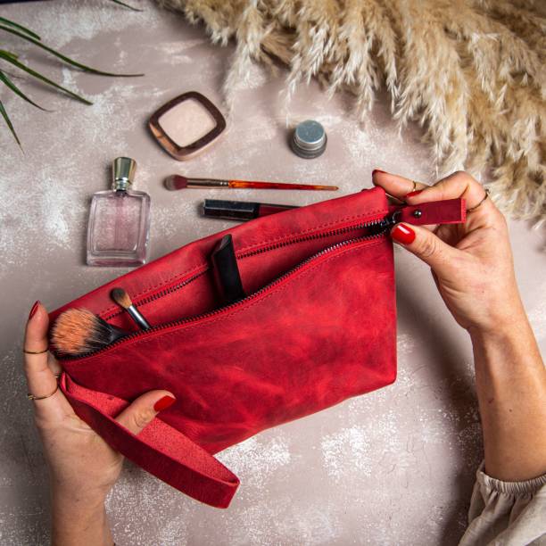 istock Top view of woman's hands opening a red handmade leather makeup bag 1419272427