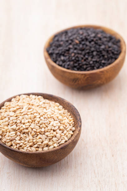 istock White sesame and black sesame seed on wooden bowl. 1419272448