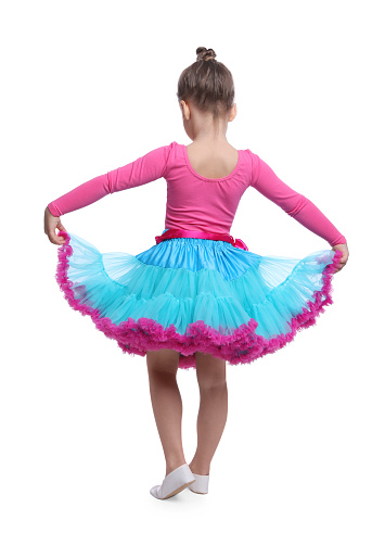 Cute little girl in costume dancing on white background, back view