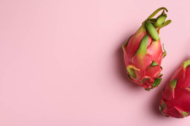 istock Delicious pitahaya fruits on light pink background, flat lay. Space for text 1419274497