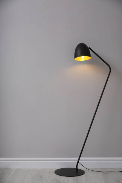 istock Modern floor lamp near light grey wall indoors, space for text. Interior element 1419277306
