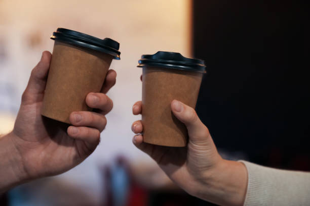 istock Couple with takeaway coffee cups in cafe, closeup 1419278193