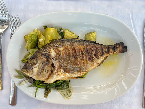 Grilled sea bass served with vegetables