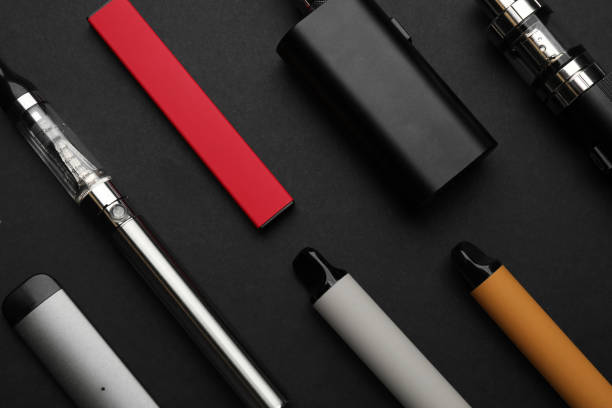 istock Many electronic smoking devices on black background, flat lay 1419279447
