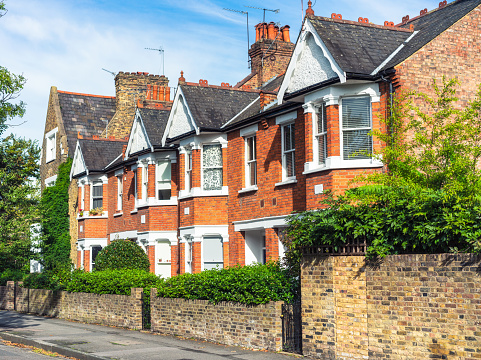 A street of old fashioned terraced houses, on a quiet street in East London.