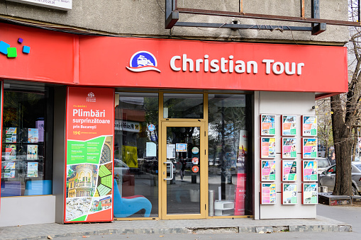 Bucharest, Romania, 7 November 2021: Christian Tour travel agency in the city center in a sunny autumn day