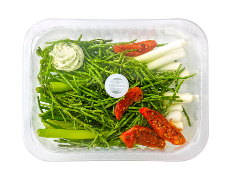 samphire and spring onion with sun-dried tomato in a steam tray, isolated on white