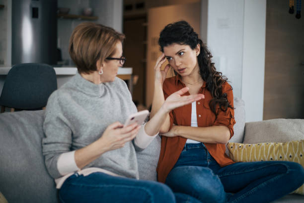 Young woman is arguing with her mother stock photo