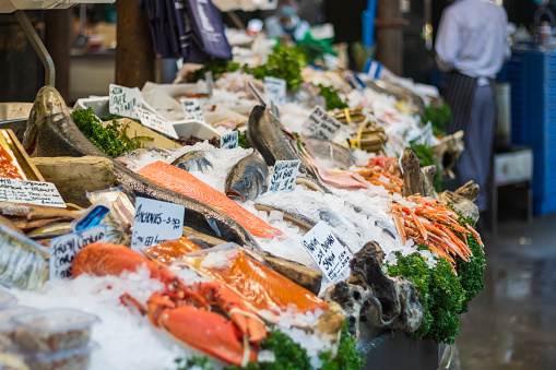 Variety of fish displayed on ice at a fishmonger in Borough Market in London, England