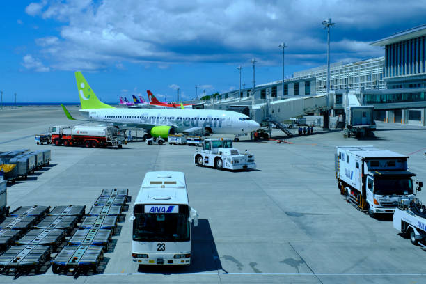 Mostly LLC airliners parked at Naha Airport jet bridges stock photo