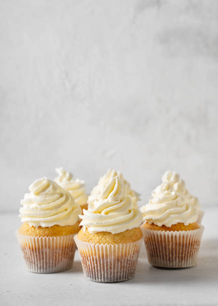 Vanilla cupcakes close up on white background