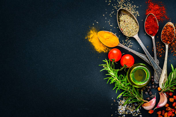 istock Spices, condiments and herbs on black background. Copy space 1419288437