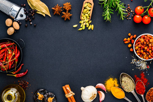 istock Scented herbs and spices frame on black background. Copy space 1419288475