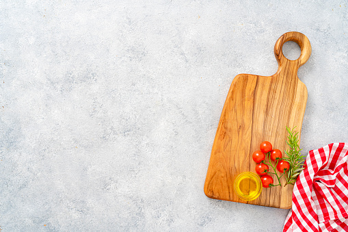 Cherry tomatoes  on cutting board over concreat table background , flat lay image with copy space for your text