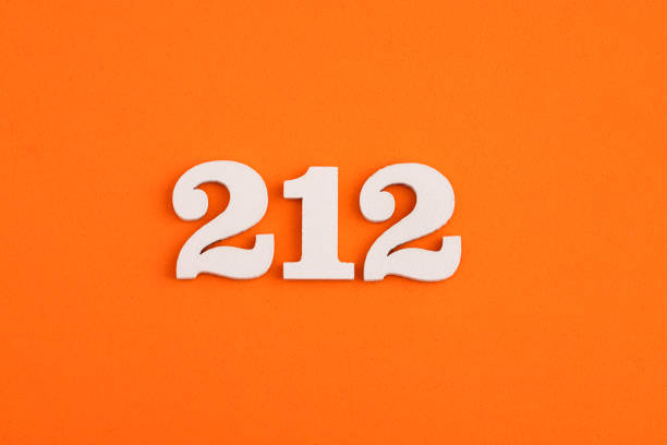 White wooden number 212 on eva rubber orange background