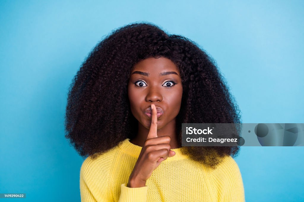 Photo of gorgeous lady hand finger cover mouth touch lips not speak show shut up symbol isolated on blue color background Photo of gorgeous lady hand finger cover mouth touch lips not speak show shut up symbol isolated on blue color background. 20-24 Years Stock Photo