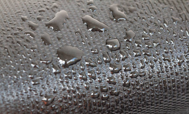 istock Water droplets on the rubber membrane. Waterproofing...  Close-up selective focus area. 1419290521