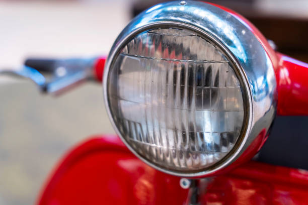 istock headlight, handlebar and control levers of a vintage red scooter. 1419291942