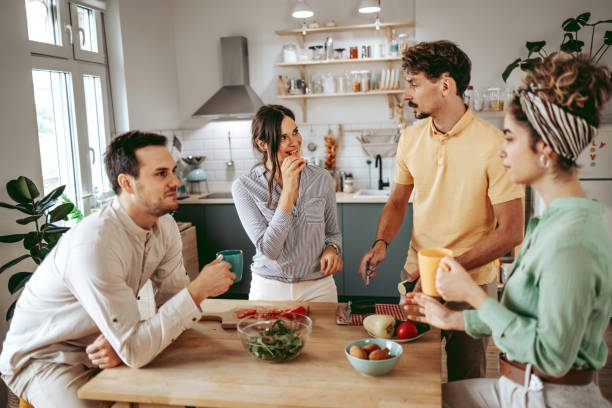 istock Group of young beautiful people making a meal in the kitchen 1419292189