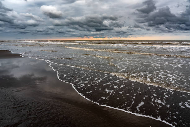 istock Waves on the sea beach on a cloudy rainy day 1419297020