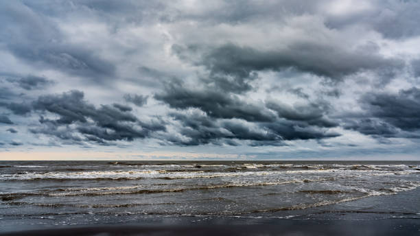 istock Waves on the sea beach on a cloudy rainy day 1419297448