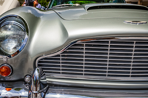 Highlands, NC - June 11, 2022: Close up detail view of a 1965 Aston Martin DB5 Hardtop Coupe headlights and grille at a local car show.