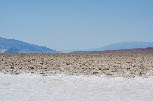 Dry flat salt landscape at the Badwater Basin at Death Valley National Park, California, USA. Seen a hot summer day.