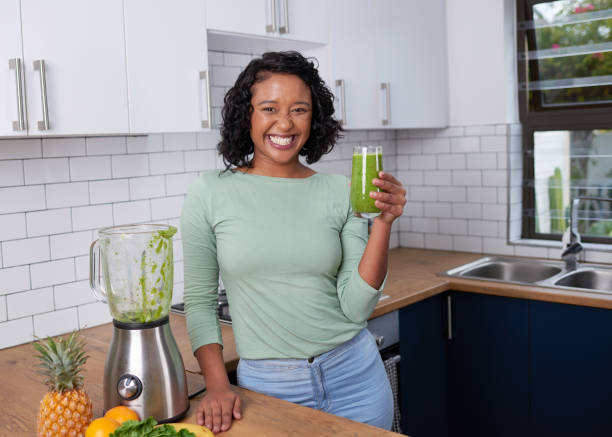 istock A young multi-ethnic woman poses with her freshly made smoothie in the kitchen 1419300801