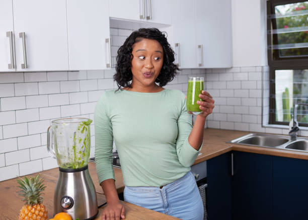 istock A young multi-ethnic woman looks at her fresh smoothie with expressive eyes 1419301859