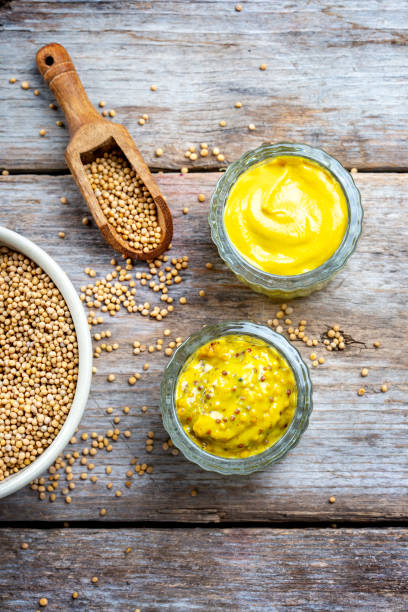 istock Different types of mustard and mustard seeds on a rustic wooden board 1419302853